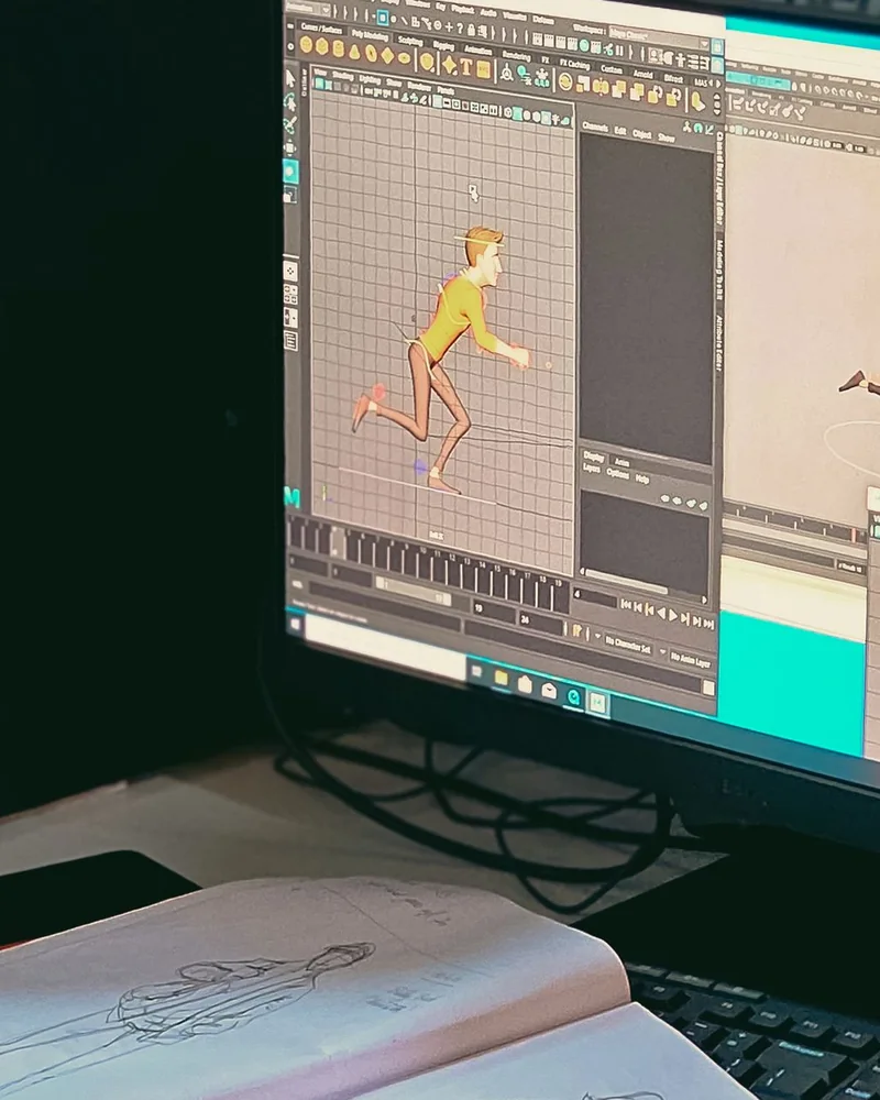 Pantalla con un personaje animado y una línea de tiempo, junto a un cuaderno con bocetos de la misma figura